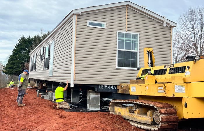 Manufactured Home being set up on concrete block foundation.